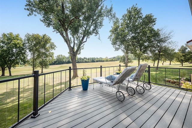 wooden terrace with a rural view and a lawn