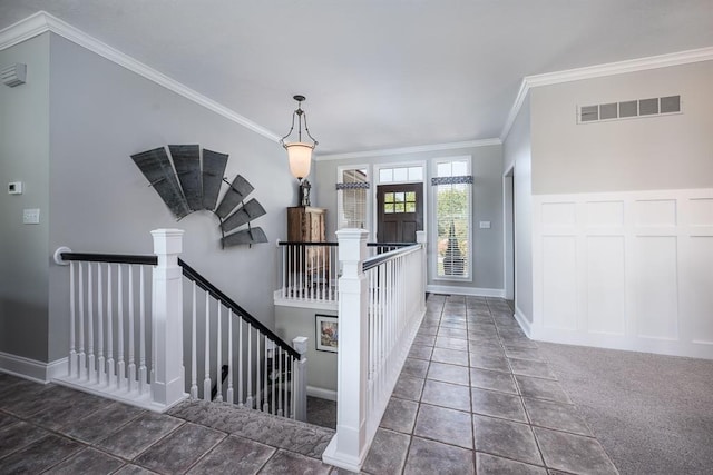 tiled entryway featuring ornamental molding