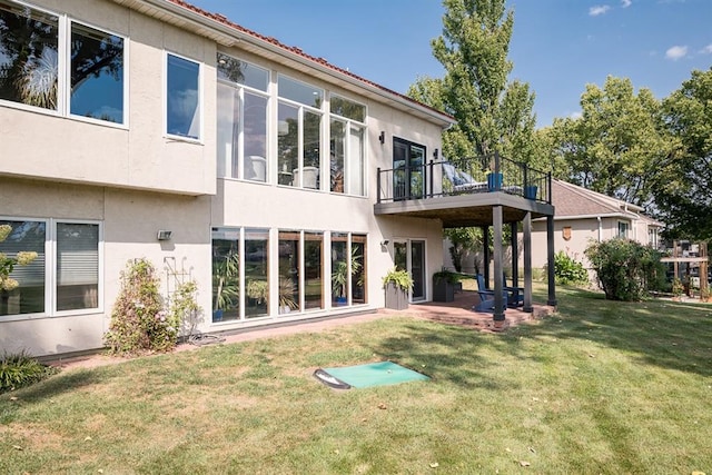 back of house featuring a patio and a lawn