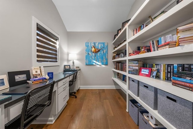 office space with dark wood-type flooring and vaulted ceiling