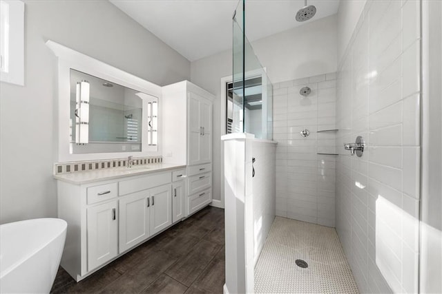 bathroom featuring vanity, plus walk in shower, and hardwood / wood-style flooring