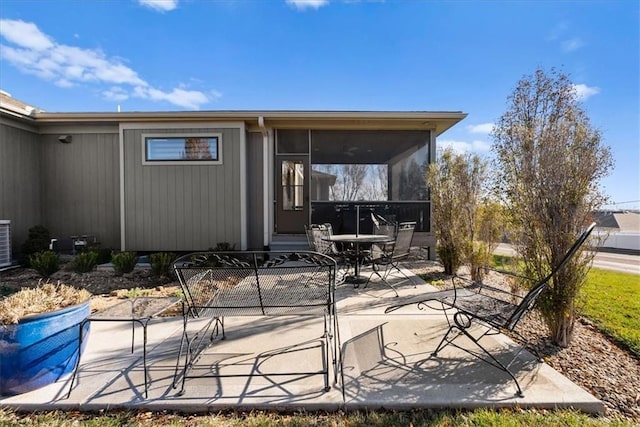 rear view of property with a patio and a sunroom