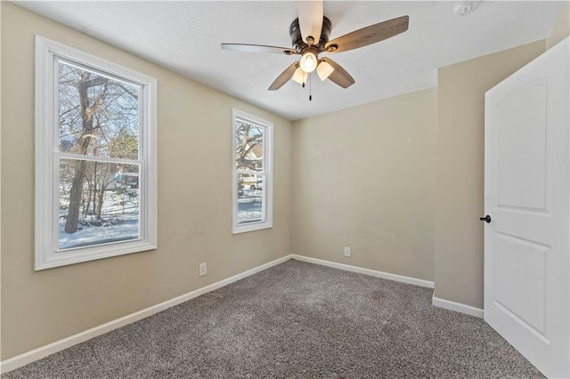 carpeted empty room with baseboards and ceiling fan