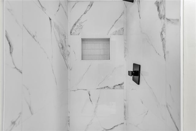 interior details with a tile shower