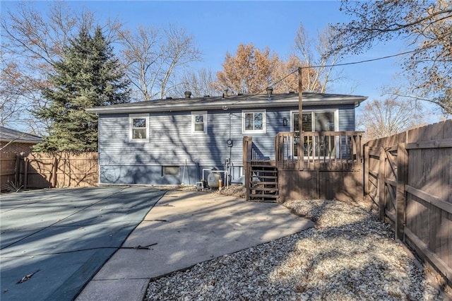 back of property featuring a swimming pool side deck and a patio