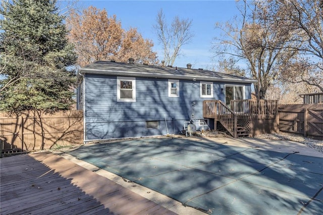 rear view of house featuring a swimming pool side deck