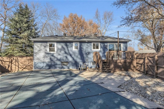 back of house with a swimming pool side deck and a patio