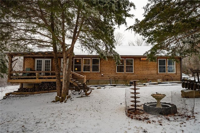 snow covered property featuring a deck