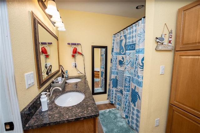 bathroom featuring a shower with curtain, vanity, and wood-type flooring