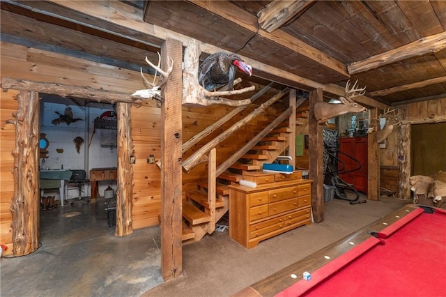 basement with wooden walls and billiards