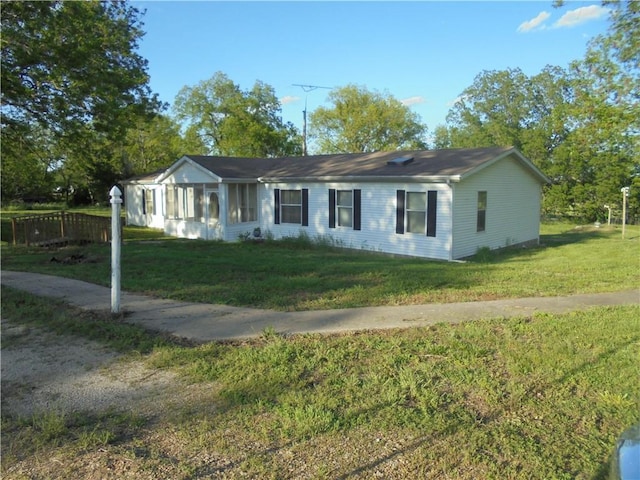 ranch-style home featuring a front yard