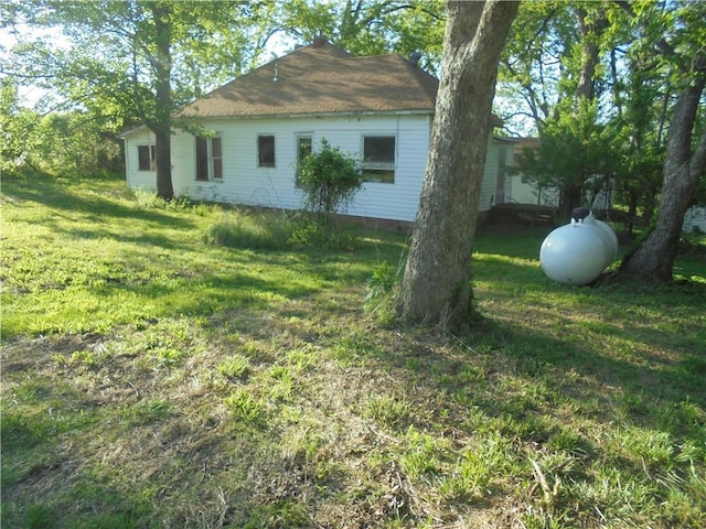 view of side of property with a lawn