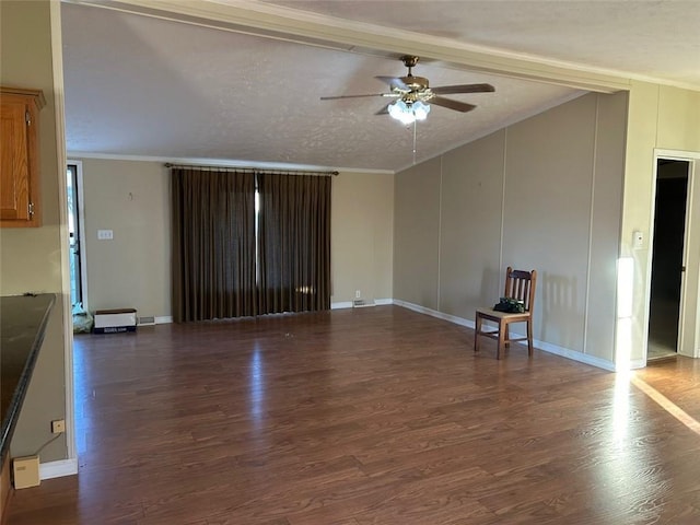 unfurnished living room featuring a textured ceiling, dark hardwood / wood-style floors, ceiling fan, and ornamental molding