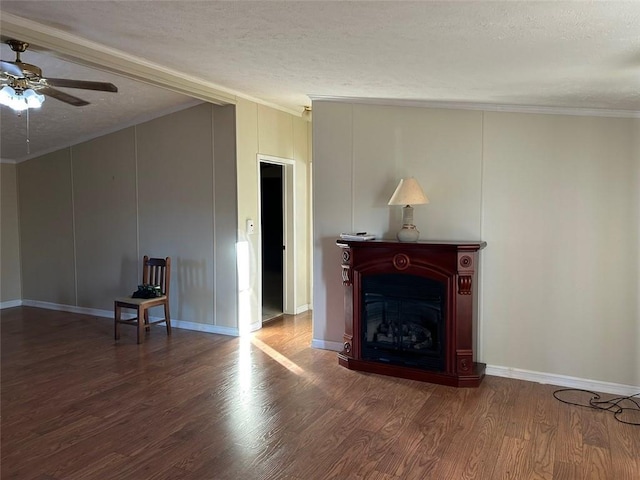 unfurnished living room with hardwood / wood-style floors, a textured ceiling, and ornamental molding