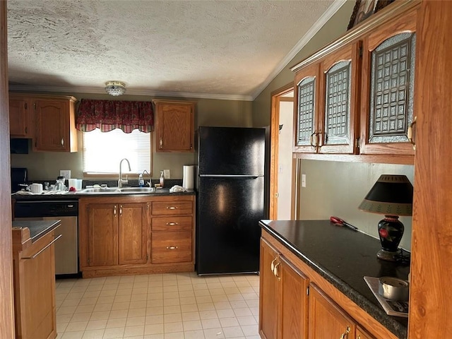 kitchen featuring sink, black fridge, crown molding, a textured ceiling, and vaulted ceiling