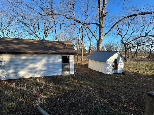 view of side of home featuring an outbuilding