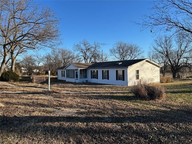 view of front of property featuring a sunroom