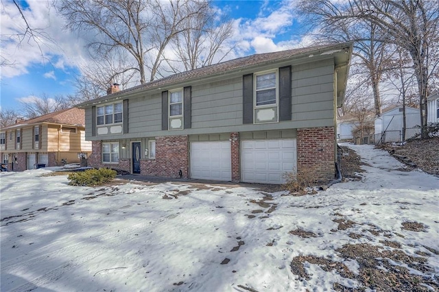 view of snow covered exterior with a garage