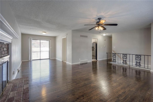 unfurnished living room with dark wood-type flooring, ceiling fan, and a fireplace