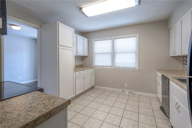 kitchen with white cabinetry, black dishwasher, a textured ceiling, and light tile patterned floors