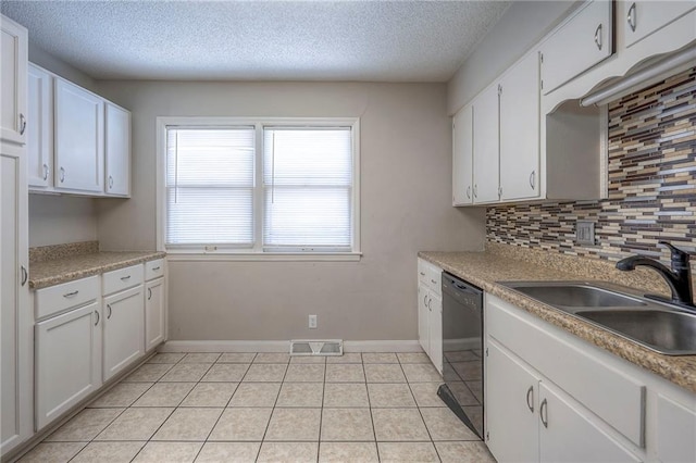 kitchen featuring sink, dishwasher, white cabinetry, tasteful backsplash, and a textured ceiling