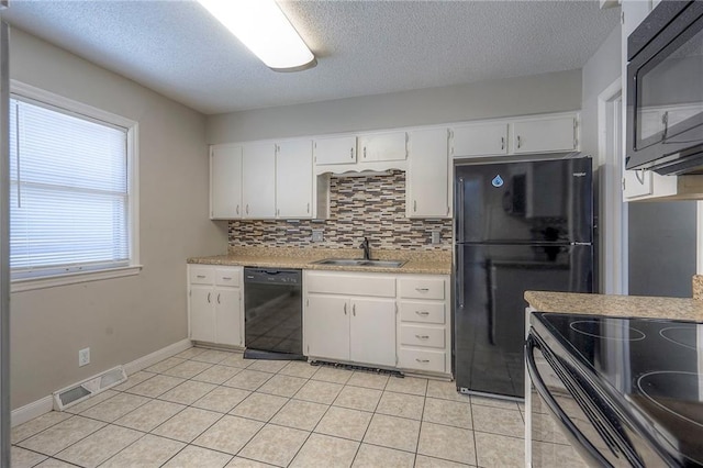 kitchen featuring tasteful backsplash, white cabinets, sink, and black appliances