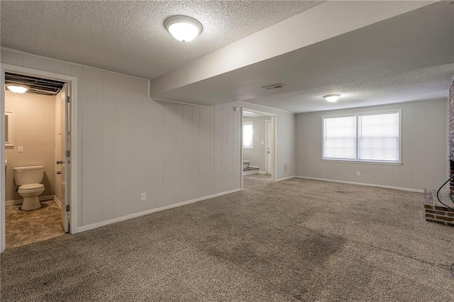 basement with carpet floors and a textured ceiling