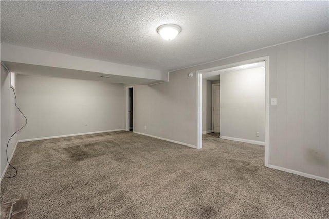 basement with carpet floors and a textured ceiling