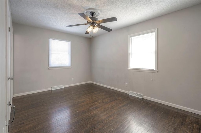 unfurnished room featuring ceiling fan, dark hardwood / wood-style floors, and a textured ceiling