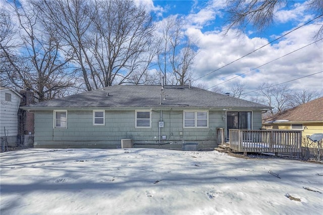 snow covered property featuring a deck