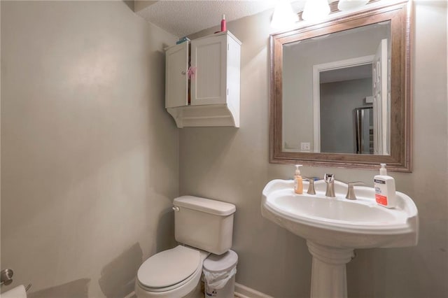 bathroom featuring toilet and a textured ceiling