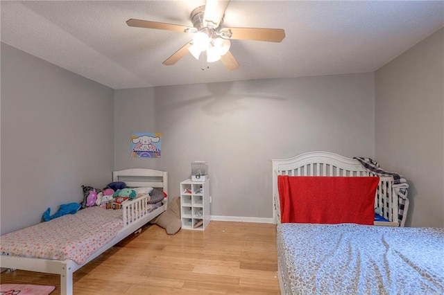 bedroom featuring ceiling fan and light hardwood / wood-style floors