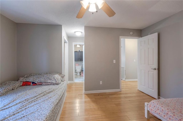 bedroom featuring ceiling fan, light hardwood / wood-style floors, and ensuite bathroom