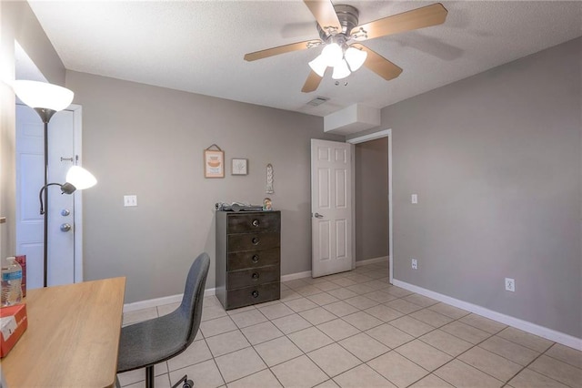 tiled office space featuring ceiling fan