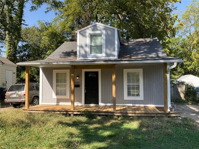 view of front of property with covered porch and a front lawn