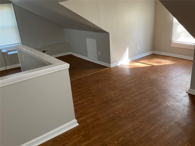 bonus room featuring dark hardwood / wood-style flooring and vaulted ceiling