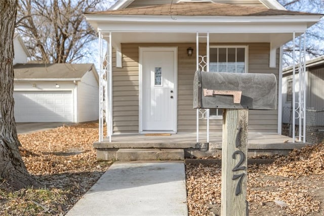 view of front of property with a garage and an outbuilding