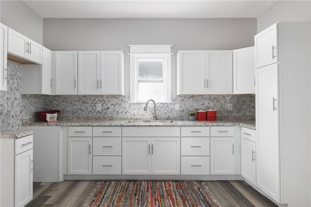 kitchen featuring dark hardwood / wood-style floors, white cabinetry, and sink