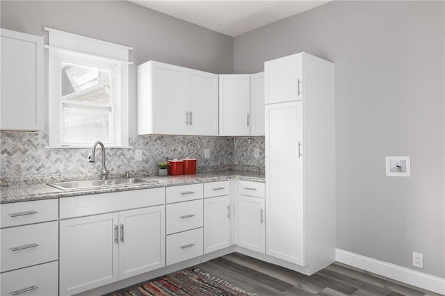 kitchen featuring tasteful backsplash, dark hardwood / wood-style flooring, white cabinetry, and sink