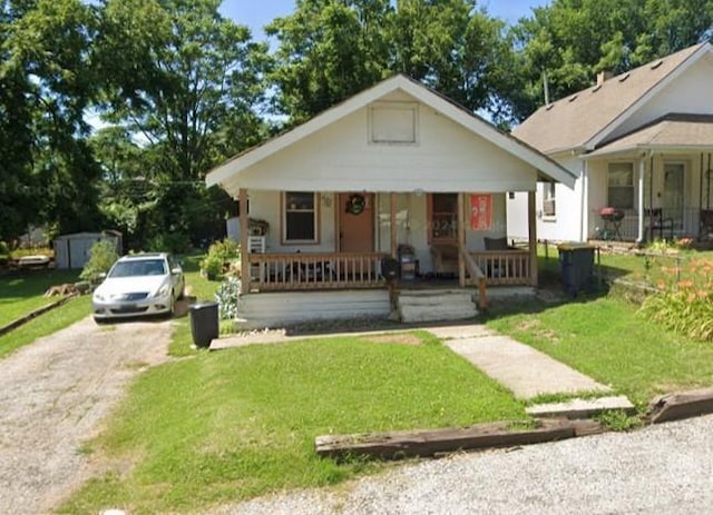 bungalow featuring a front lawn and covered porch