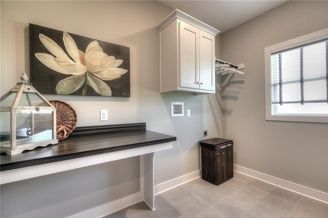 washroom with electric dryer hookup, light tile patterned floors, hookup for a washing machine, and cabinets