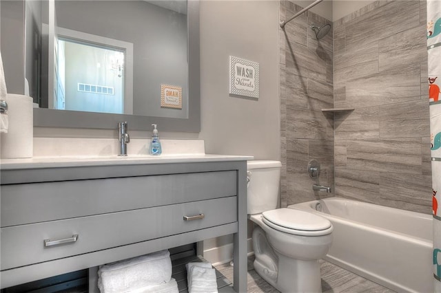 full bathroom with vanity, toilet, and tiled shower / bath