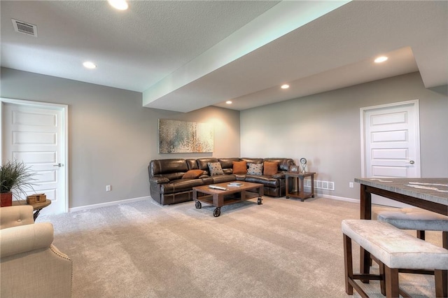 living room with light colored carpet and a textured ceiling