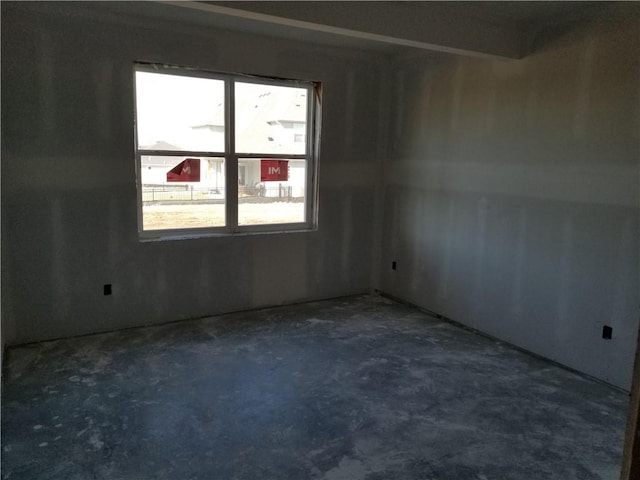 spare room with concrete floors