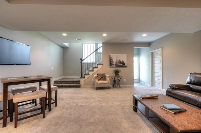 living area featuring recessed lighting, visible vents, stairway, light carpet, and baseboards