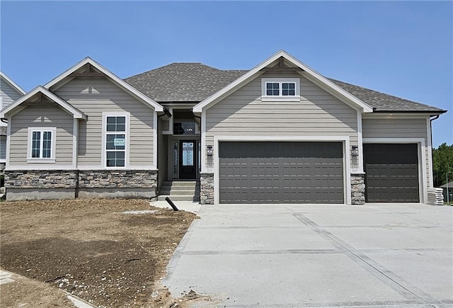 14608 Aspen Cir, Basehor, KS 66007 - craftsman house with a garage, stone siding, driveway, and roof with shingles