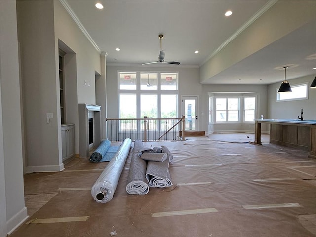 14608 Aspen Cir, Basehor, KS 66007 - unfurnished living room with crown molding, recessed lighting, ceiling fan, a sink, and a fireplace