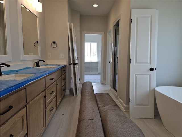 14608 Aspen Cir, Basehor, KS 66007 - bathroom featuring double vanity, a soaking tub, a shower with shower door, and recessed lighting