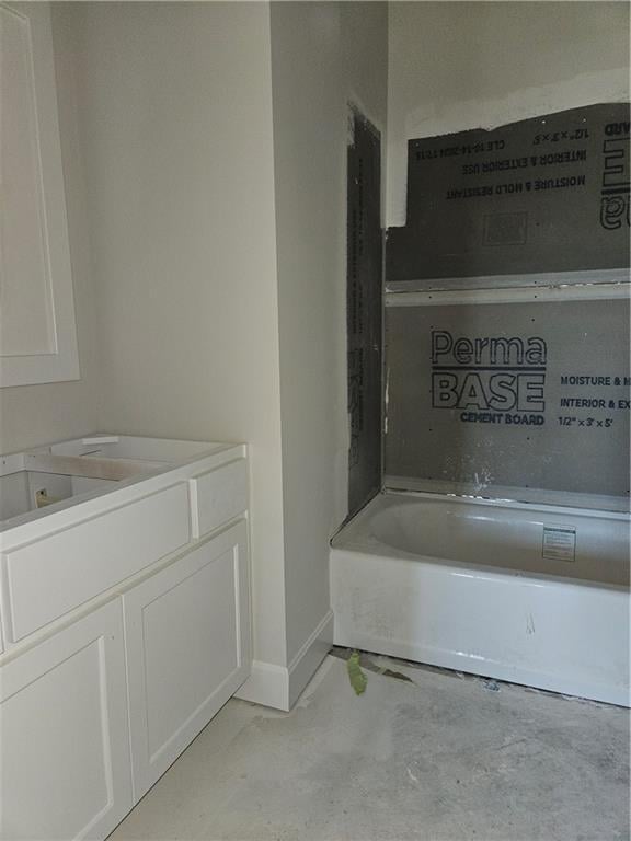 14608 Aspen Cir, Basehor, KS 66007 - full bath with vanity, a bathtub, concrete flooring, and baseboards
