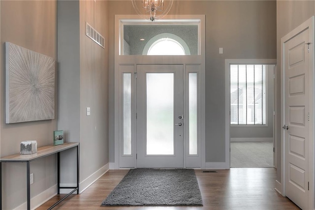 14608 Aspen Cir, Basehor, KS 66007 - foyer entrance with wood finished floors, baseboards, and a chandelier
